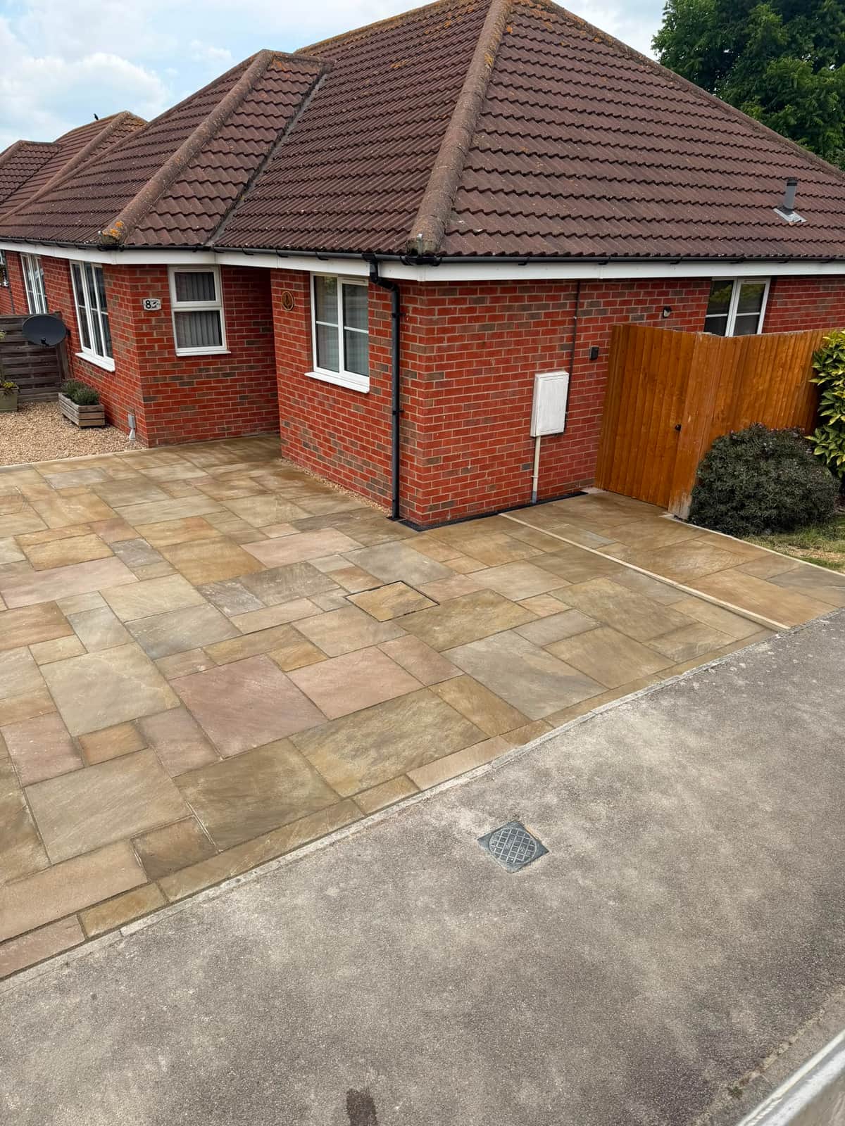 Sandstone driveway laid up to the side gate of a bungalow